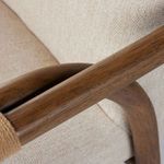 Low angle side view of Rosie desk chair highlighting chrome swivel base with caster wheels and fabric seat