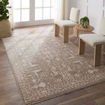 Lechmere Medallion rug in natural light setting with two textured cream chairs and wooden floor