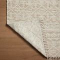 Corner of rug flipped over to show the reversible design and pattern on back side