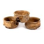 Three teak bowls arranged with one slightly elevated, showcasing different sizes and wood markings