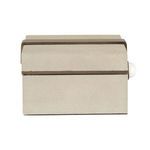 Side view focusing on textured shagreen and white knob extending from brass strap.