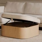 Side view of open Sonny ottoman with visible hydraulic lift and wood base in living room