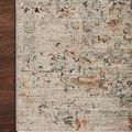 Top view close-up of Axel Silver/Spice rug edge on dark hardwood floor highlighting color variation and weave
