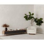 Oscy swivel chair styled in minimal living room with sideboard and large green plant