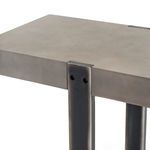 Detail shot of black metal leg with rivets attaching to concrete top on Mercury Console