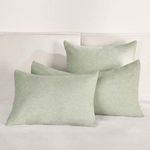 Three shams styled on a neutral bed showing scale and room context