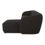 Side profile of Faye sectional highlighting the curved backrest and the plush boucle texture