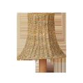 Bell-shaped natural woven chandelier shade with slightly flared bottom edge on wooden base