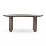 Front view of the round dining table with visible rounded edges and three curved legs