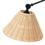 Close-up of woven rattan texture on the conical lamp shade with black pivot joint