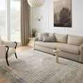 Soho Charcoal / Multi Rug shown in living room with beige sofa, armchair, and wall art