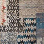 Top view showing Zevi rug among layered global patterned rugs with varied textures