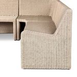 Textured side detail of banquette without cushions showing rattan weave pattern