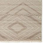 Detailed shot of mid-section displaying tightly woven diamond and linear patterns with fringed edge