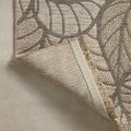 Folded back corner showing rug's polypropylene backing and stitched edge