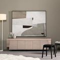 Abstract landscape painting mounted above wooden console with black stools and floor lamp