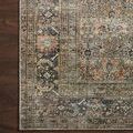 Close-up of rug corner on dark wood floor highlighting border details and color gradient