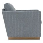 Side profile highlighting vertical striped upholstery and wooden base of swivel chair