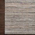 Close-up of Jamie Natural Slate Rug corner on dark wood floor highlighting weave texture and color contrast