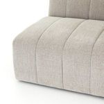 Repeated side angled view of sandstone Langham sectional showcasing modular design and channel tufting