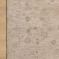 Close-up of rug corner on wood floor showing detailed pattern and clean, finished edge