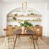 Jamie Natural Sand Rug styled in a bright dining room with wood table and chairs on top