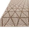 Close-up angled view showing flat weave and detailed mocha geometric lines on beige Isle Indoor/Outdoor rug