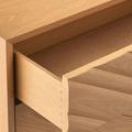 Open drawer side profile revealing dovetail joints and wood tone inside