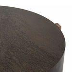 Close-up showing curved iron surface and rough texture near oak support