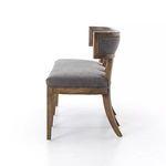 Profile view focused on bench’s sharp leg curves and padded backrest wrap