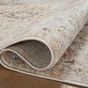 Partially rolled section displaying rug’s backing and thickness on hardwood floor
