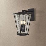 Jantzen Wall Sconce mounted on a beige textured wall showing the right side angle