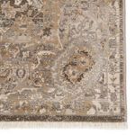 Close-up of rug's intricate border pattern with metallic silver and gold threaded accents