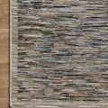 Top-down view of Soho Multi Sand Rug corner showing the clean, fringed border on wood floor