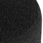 Close-up of dark charcoal fabric texture highlighting soft, looped fibers on the ottoman