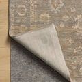 Louisa Lagoon Ivory Rug corner folded back to expose underside and rug pad on wooden floor