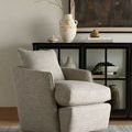 Whittaker Swivel Chair shown in light styled living room with cabinet, rug, and decorative items