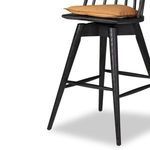 Texture detail of wire-brushed black oak grain on stool leg and rung