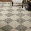 Close view of Francis Rug corner showing charcoal diamond pattern with looped wool texture