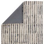 Corner turned over to reveal solid gray fabric backing with Nikki Chu branding