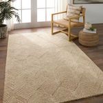 Rug styled in a bright room with wood flooring, featuring a wooden chair and woven ottoman