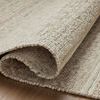 Curled edge of rug displaying thickness and tight weave texture