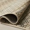 Rolled section of Saylor Mosaic Field Rug emphasizing woven texture and flexibility