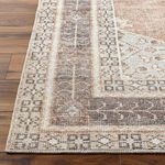 Detailed macro close-up of the Lila rug’s border corner highlighting woven texture and pattern in gray and brown