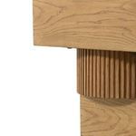 Partial close-up of fluted circular midsection connecting the top and base of Leland table