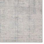 Zoomed view of rug surface highlighting detailed linear blue and cream pattern texture