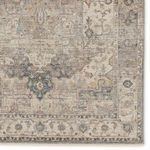Close-up of corner showing detailed border pattern with faded, vintage-inspired color variation
