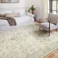 Rosette Ivory / Silver Rug in bright living room with white sofa and light wood chair