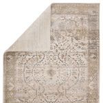 Corner close-up highlighting the contrast of cream, gray, and muted gold fibers in vintage medallion rug