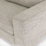 Angled close shot highlighting corner seat depth and gray upholstery texture